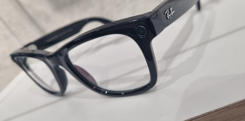 A pair of black Ray-Ban Meta glasses on a counter.