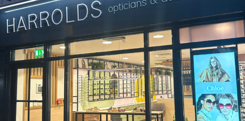 A photo of the outside of one of the Harrold Opticians Practices, showing the logo on the outside of the building and a clear view inside the building.