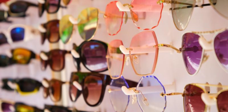 A shelf full of sunglasses in different styles and shades
